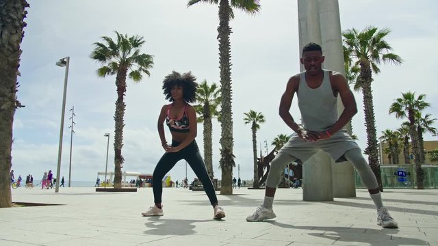 Black couple doing exercise outdoors