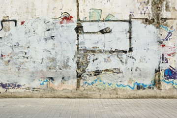 Grunge graffiti painted wall and sidewalk. Street style background and empty copy space for...