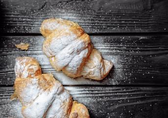  croissants on dark wooden background close-up top view
