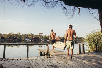 Two Men Carrying a Canoe