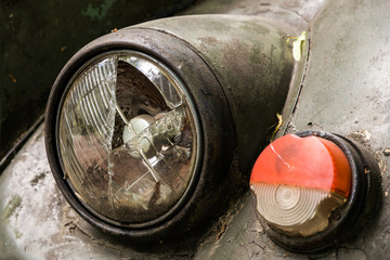 Old Soviet car. Broken glass lights and turn signal.