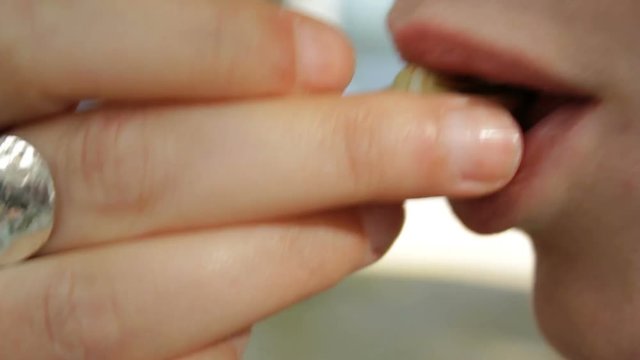 Close up of woman eating Cooked snails or escargot