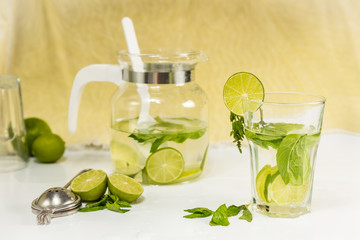 uice with lime and mint on yellow background