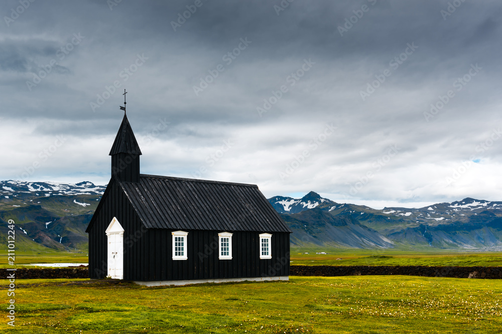 Wall mural black wooden church budakirkja at snaefellsnes, western iceland, europe.