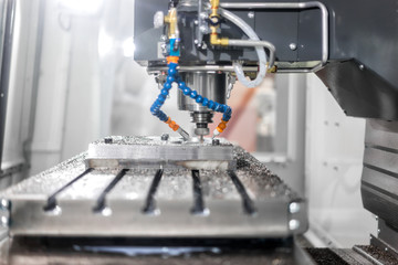 High precision CNC machining center working, operator machining automotive sample part process in...