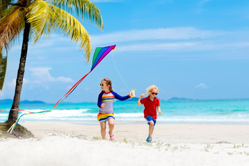 Child with kite. Kids play. Family beach vacation.
