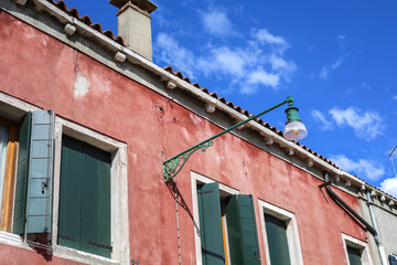 A streetlight lamp on a historic building in Venice, Italy, Europe.