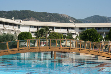 Wooden bridge over swimming pool