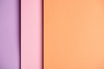 Paper sheets in pink and orange tones background