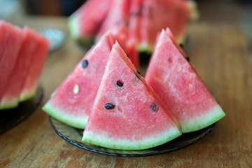 Three pieces of red watermelon lie on a plate.