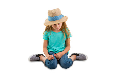 Guilty little girl sitting with her head bowed