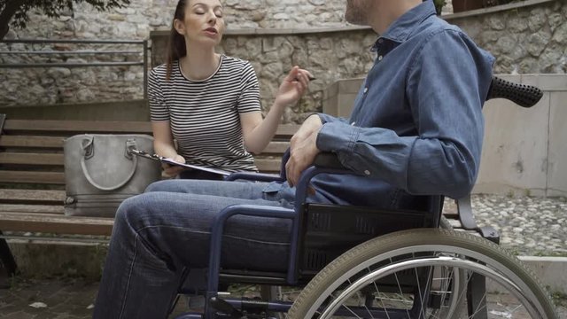 Social worker meeting a man in wheelchair
