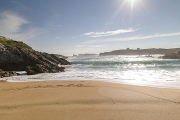 beautiful beach with waves breaking on the shore and without people
