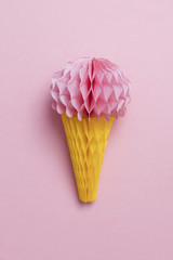 Paper ice cream cone decoration on a pastel pink background