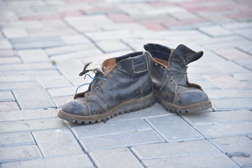 Old bad worn out dirty ragged boots shoes 