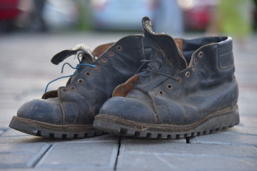 Old bad worn out dirty ragged boots shoes 