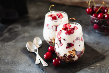 Homemade trifle pudding with freshcherry on dark background