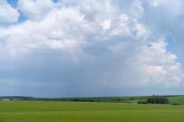 Podolia region, Ukraine. Landscape with dramatic clouds over agricultural field