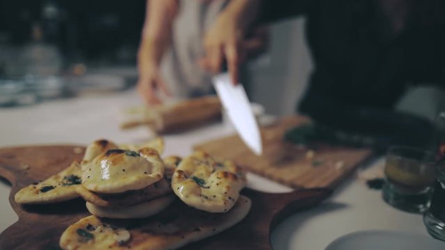Serving Garlic Bread with Parsley on a Wooden Board