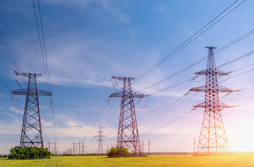 high-voltage power lines at sunset. electricity distribution station .