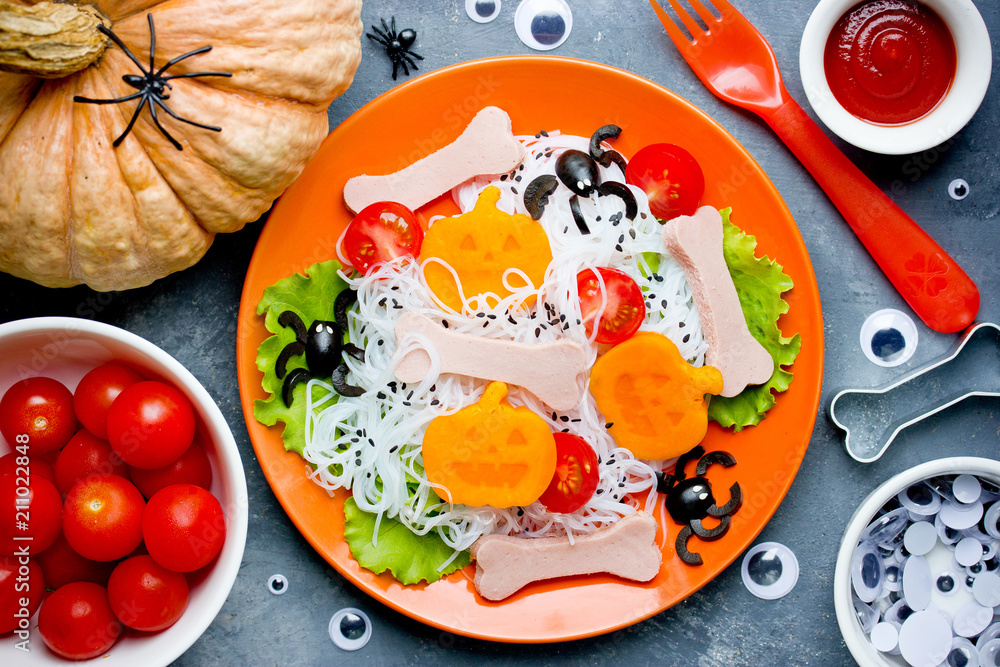 Wall mural creative idea for halloween healthy and funny food for kids - scary spaghetti with pumpkin, olives a