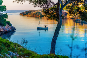Morning scene with a fisher man on the sea near Esmeralda beach, in Mallorca island, Spain © cristianbalate