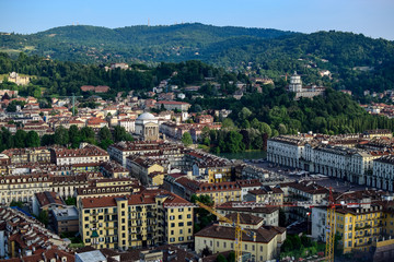 Fototapeta na wymiar View of the whole of a city and its monuments as well as a backdrop mountains, review the San Marco square from the heights. Photograph taken in Turin, Italy.