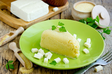 Corn porridge polenta mamaliga hominy with salty cheese on plate