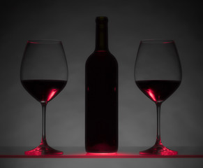 Glasses and bottle of red wine.