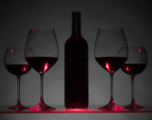 Glasses and bottle of red wine.