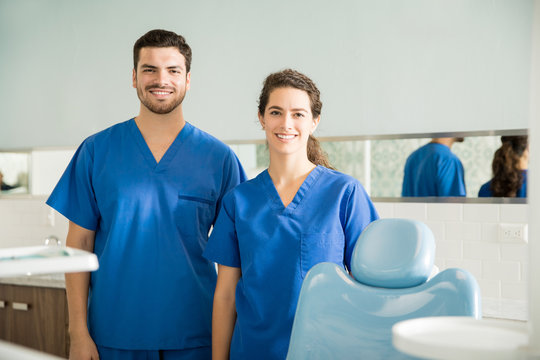 Portrait Of Smiling Male And Female Dentists At Clinic