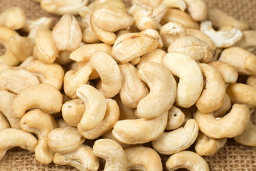 Pile of cashew nuts on sackcloth.