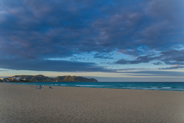 Mallorca, Dawning sky at white sand beach with sunbeds
