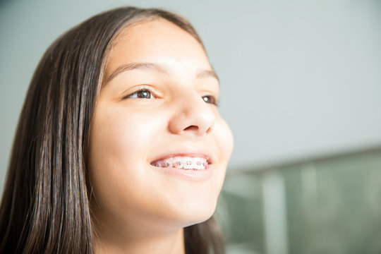 Smiling Teenage Girl With Braces In Dental Clinic