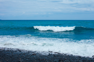 Big breaking Ocean wave on a sandy beach on the north shore of Oahu Hawaii