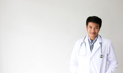 Portrait of smiling male doctor. Friendly young man doctor with a stethoscope around on neck. asian people.