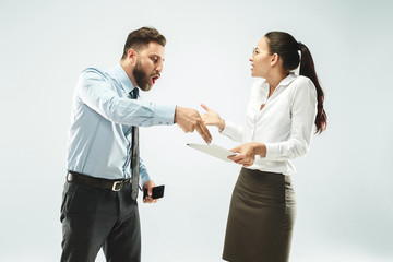 a business man shows the laptop to his colleague in the office.