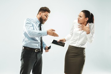 a business man shows the laptop to his colleague in the office.