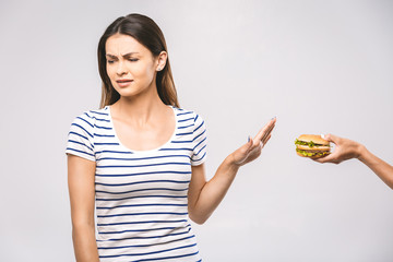 Woman on dieting for good health concept. Woman doing sign no to refuse junk food or fast food (hamburger and potato fried) that have many fat.