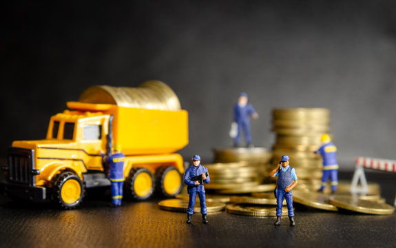 miniature security guard officers standing and protection in front of dumper truck loading the golden coins. money security protection concept