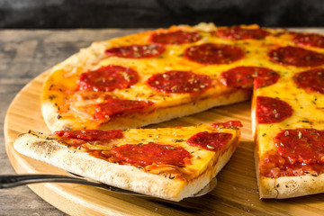 Hot italian pepperoni pizza on wooden table.