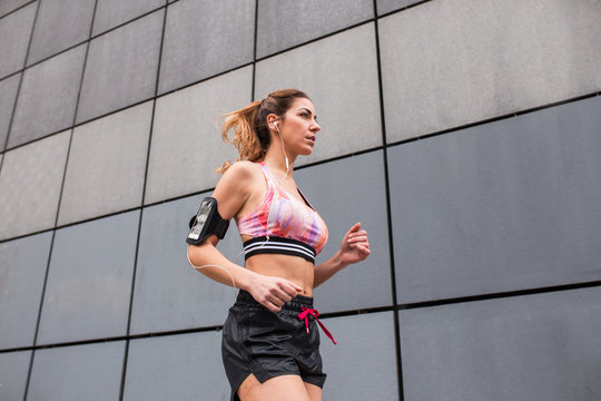 Athletic woman jogging on street
