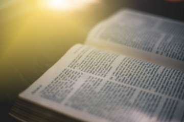 Soft focus The holy bible on wood table with copy space.christian background