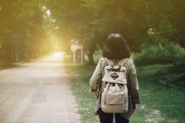 Female backpackers standing on the open road and hold the Bible. The concept goes out to share the...