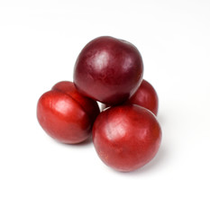 Red plums on a white background isolated