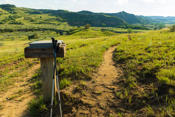 Trekking poles lean against a trail ledger in Theodore Roosevelt National Park