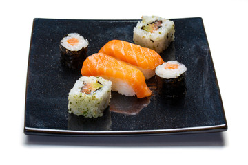 Black plate with sushi, maki and california rolls
