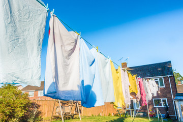 Clothes hanging to dry on a washing line in a back garden