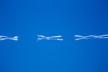Wavy Jet Trails Dissipating in a Blue Sky