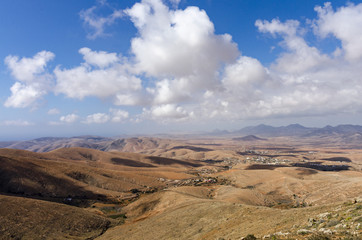 Naklejka premium Typical landscape of Fuerteventura with barren volcanic mountains - the view from Morro Velosa vantage point
